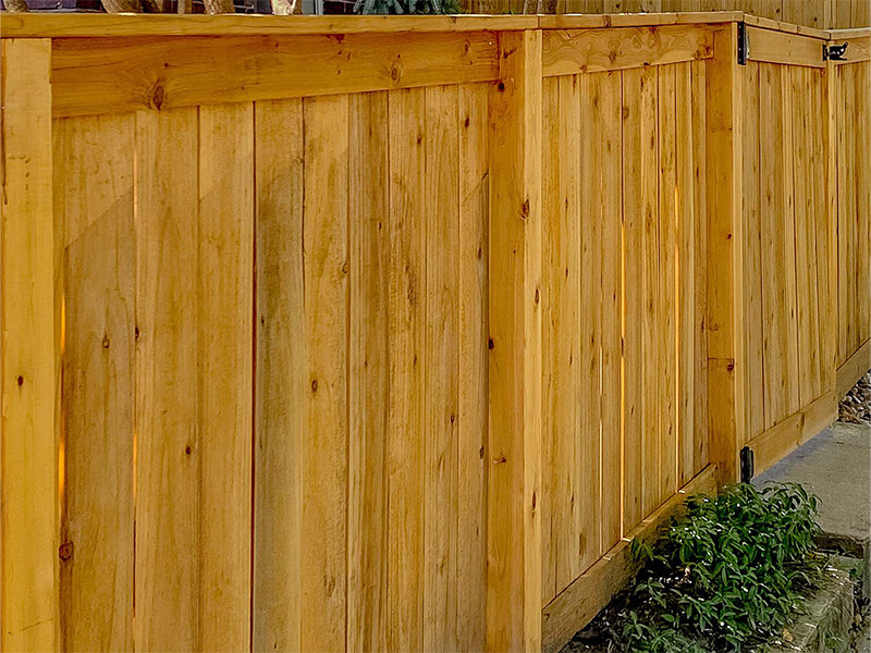 Staining wood fence before installation in Sarasota Florida